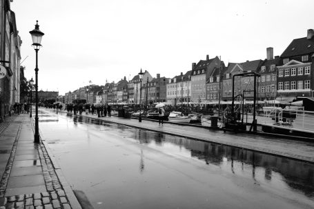 Schwarz-weiße Stadtansicht mit einem kanal und historischen Gebäuden entlang der Uferseite.